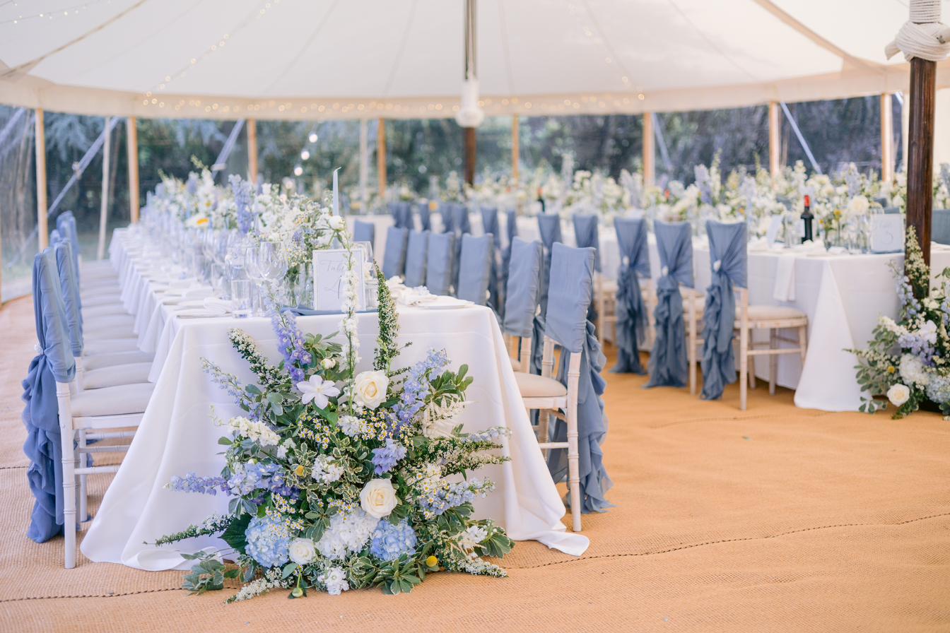 Sailcloth marquee styled with meadow flowers and dusty blue chairs, Rutland wedding