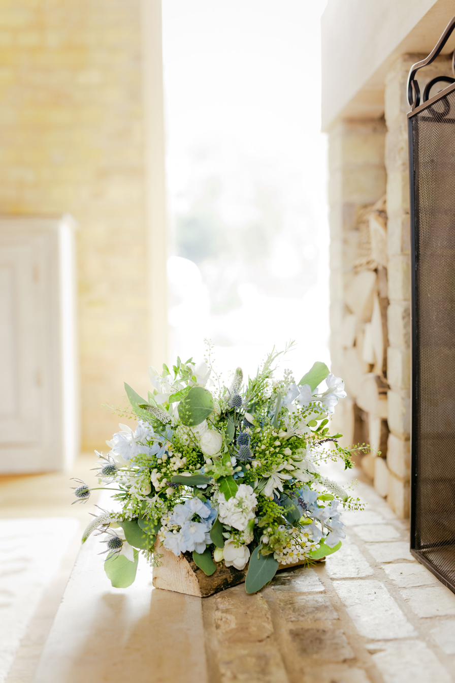 Blue and cream arrangement in a stone window, Rutland wedding