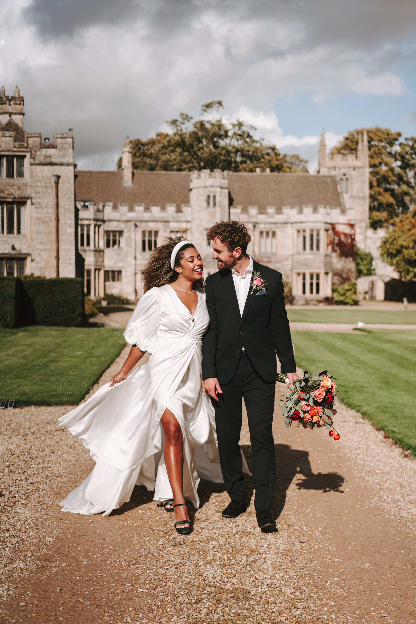 Bride and groom walking the drive at the manor house, Dionne and Alistair's manor house wedding in Lincolnshire