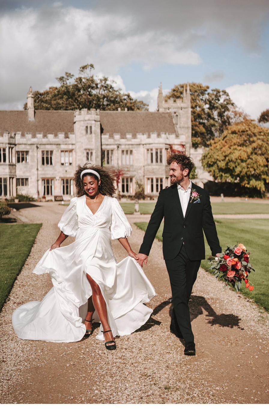 Couple walking the drive, Dionne and Alistair's manor house wedding in Lincolnshire